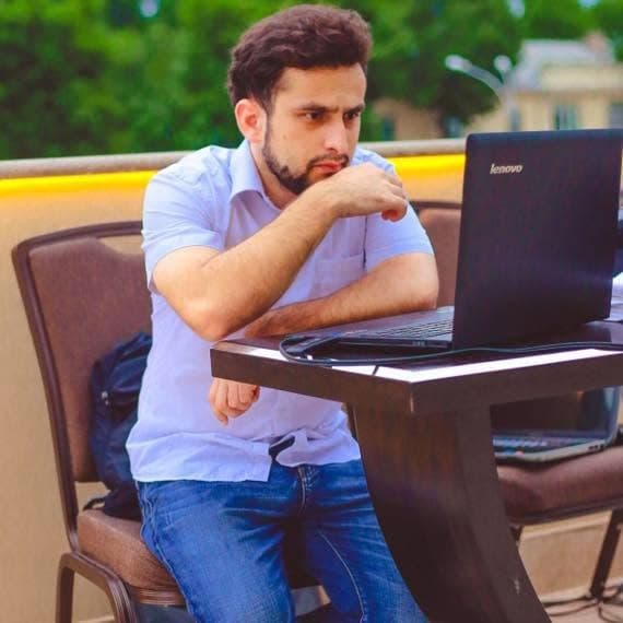 Dodikhudo Abdurahimov working on a laptop