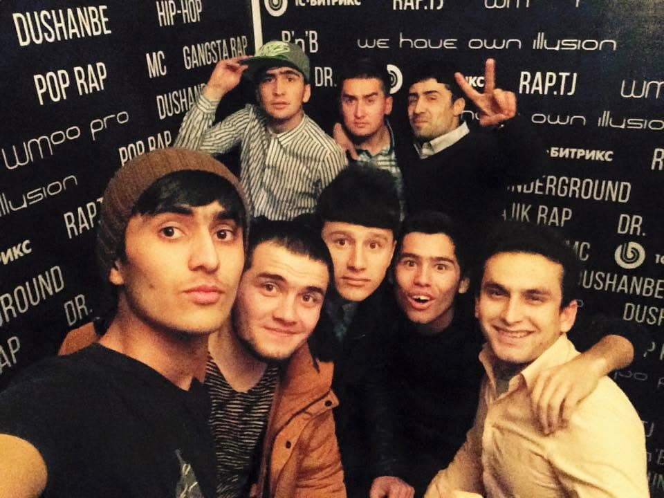 Dodikhudo Abdurahimov with the rap.tj team in front of the RAP.TJ and WMO Pro branded wall, 2015